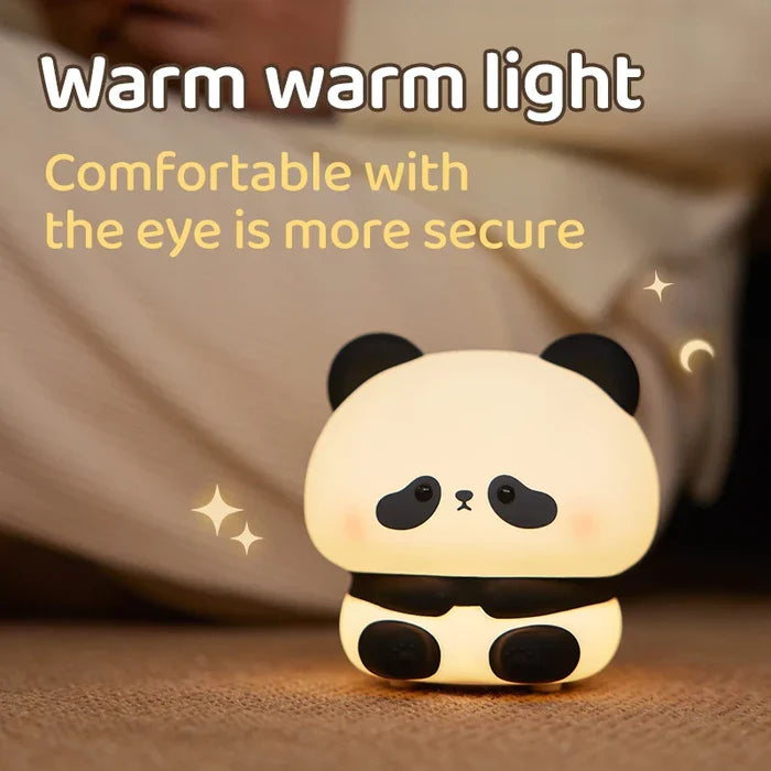 Cute panda LED night light on floor, warm glow with black eyes
