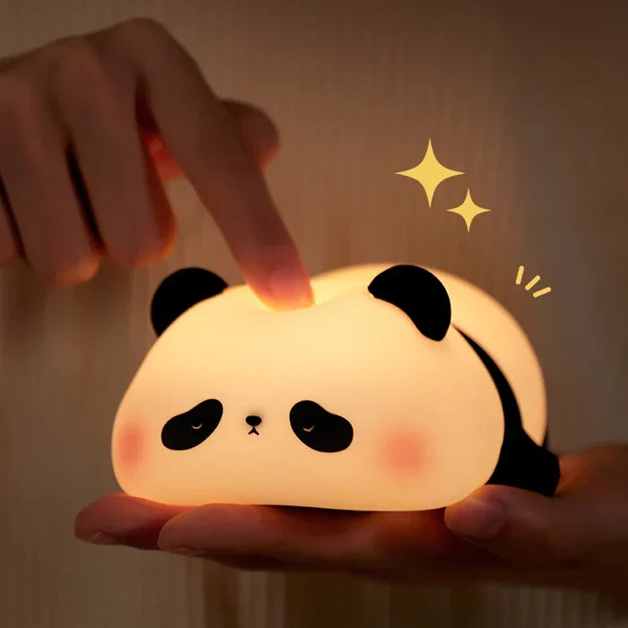 Panda LED night light held in hands, bright warm glow on face