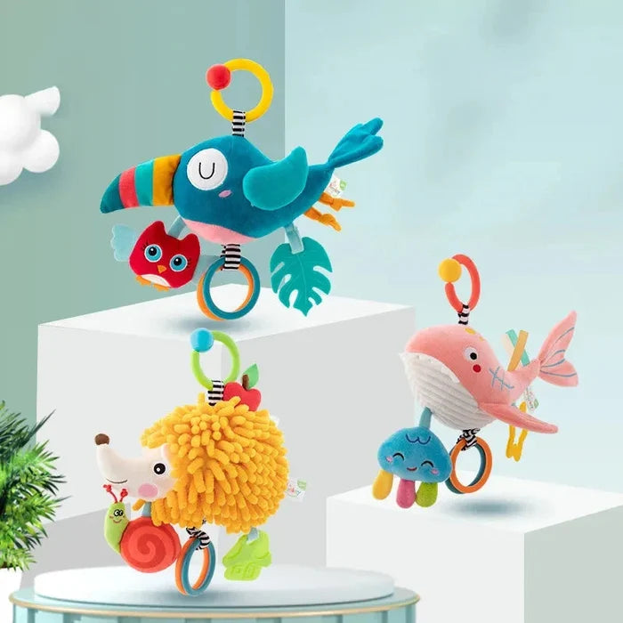 Soft hanging sea animal rattle toy with rings, whale, fish, and pom details