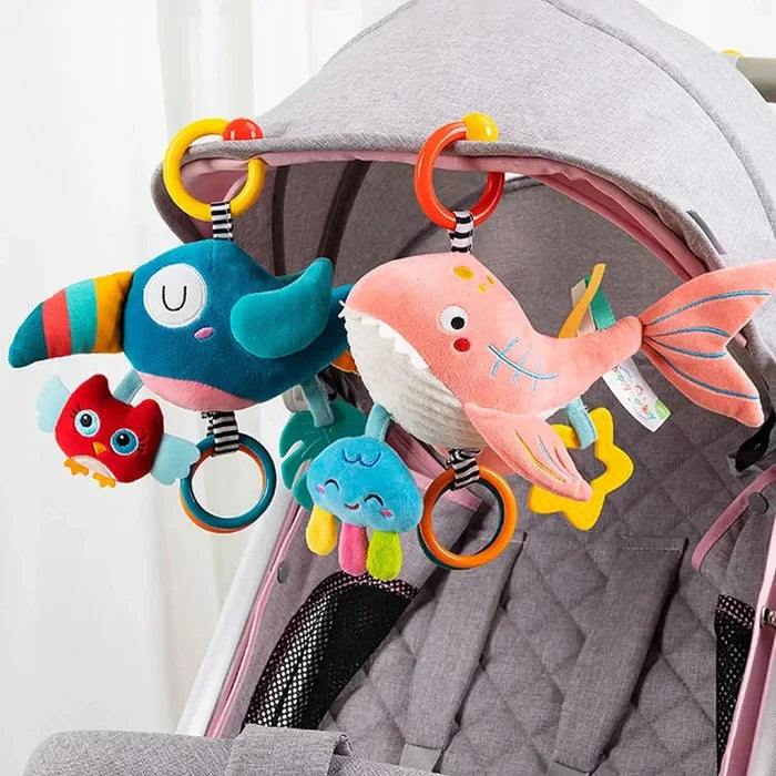 Soft hanging ocean rattle set on stroller frame with whale and pink fish