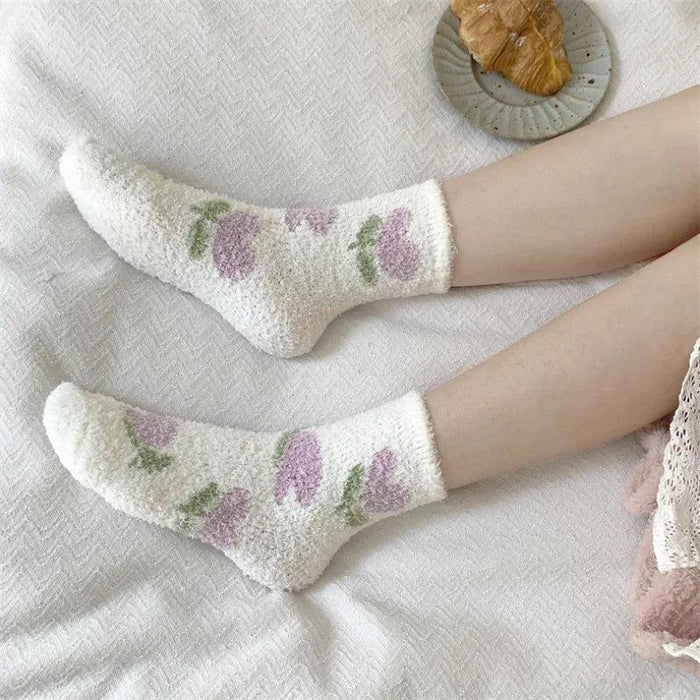 Plush sleeping socks in light purple with small berry prints and green accents
