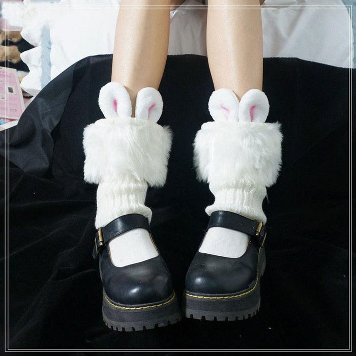 Rabbit ear socks with fuzzy white body and pink inner ears, worn with black boots