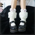 Rabbit ear socks with fuzzy white body and pink inner ears, worn with black boots
