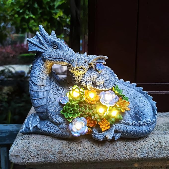 Solar LED dragon statue on stone pedestal with glowing lights and succulent flower accents