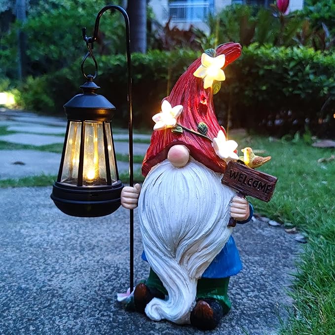 Solar garden gnome statue holding a black lantern with warm glowing lights, red flower hat