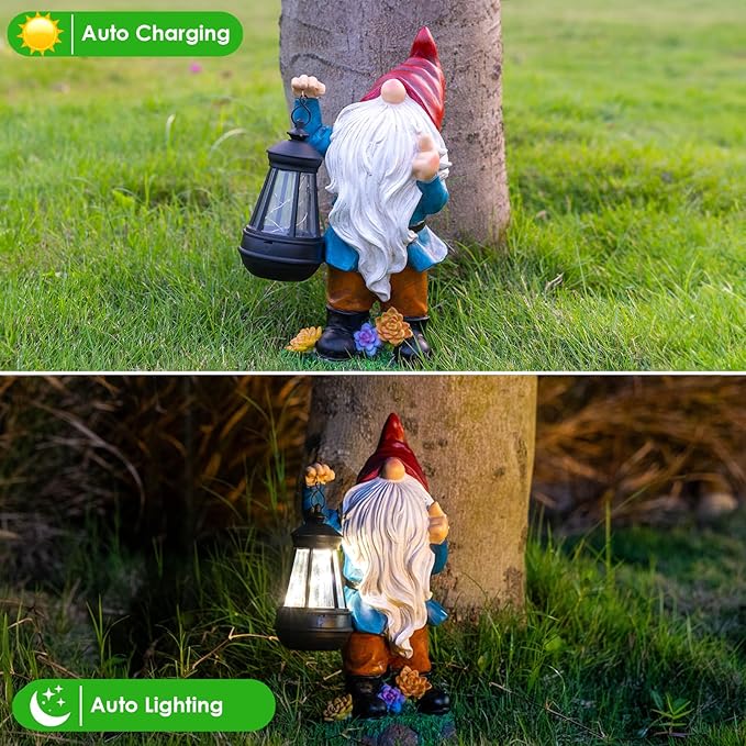Gnome garden statue with red cap and blue coat, holding solar lantern near tree trunk