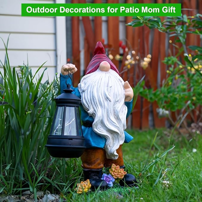 Patio yard gnome figurine in red hat and blue coat, holding lit solar lantern