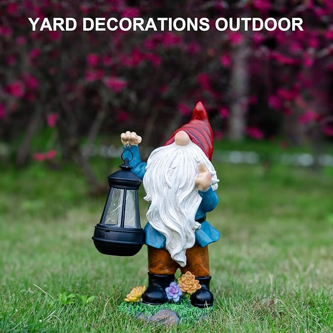 Gnome garden statue holding black solar lantern, red hat and long white beard, blue coat