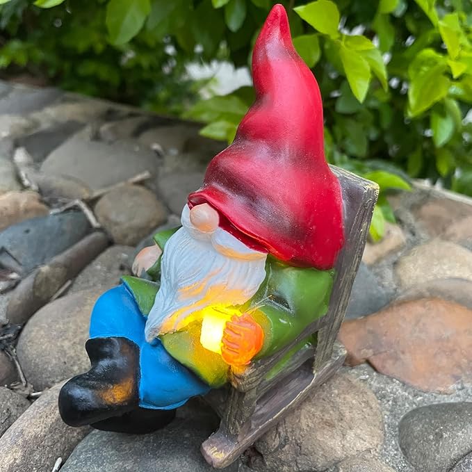 Solar gnome figurine holding a wooden panel, red hat and blue pants with glowing light