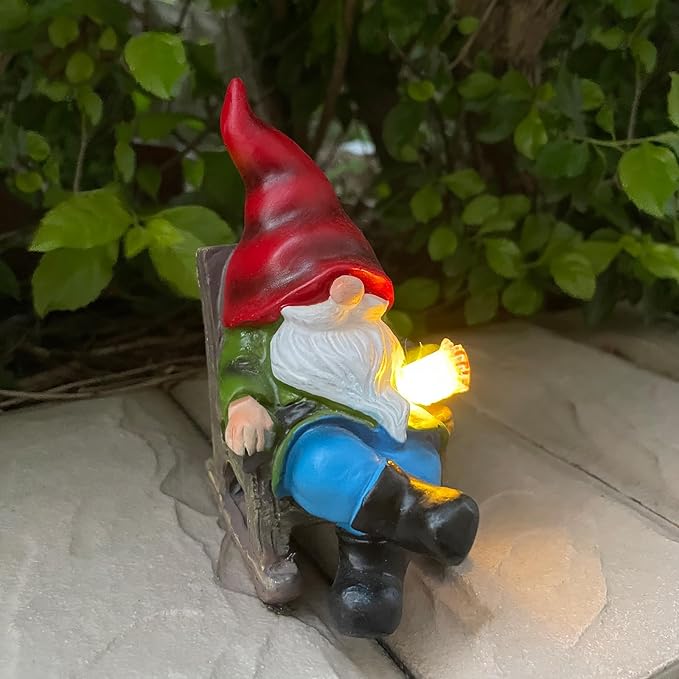 Solar gnome figurine in profile, red hat and blue pants with bright solar glow