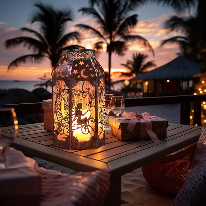 Bronze metal hanging lantern with fairy silhouette and moon stars, warm glow on table