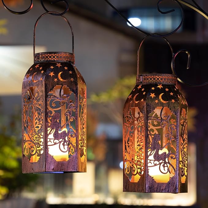 Two bronze metal hanging lanterns with fairy and moon cutouts, warm glow