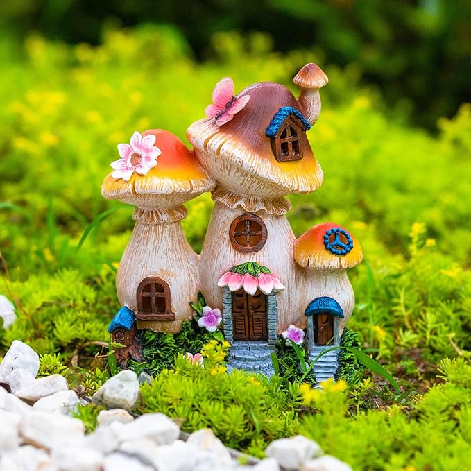 Unlit mushroom fairy house garden statue with pink blossoms, painted doors and windows