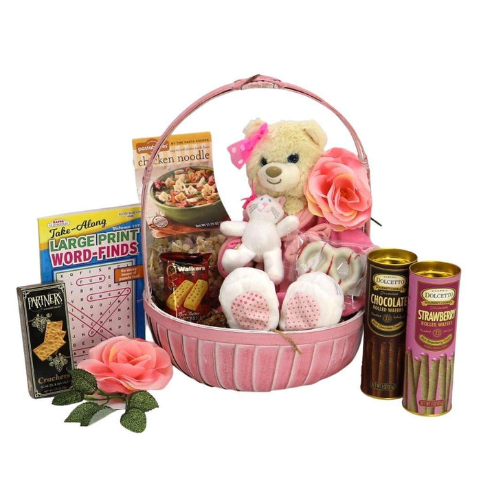 Pink gift basket with plush bear, rose, boxed crackers, and chocolate and strawberry cans