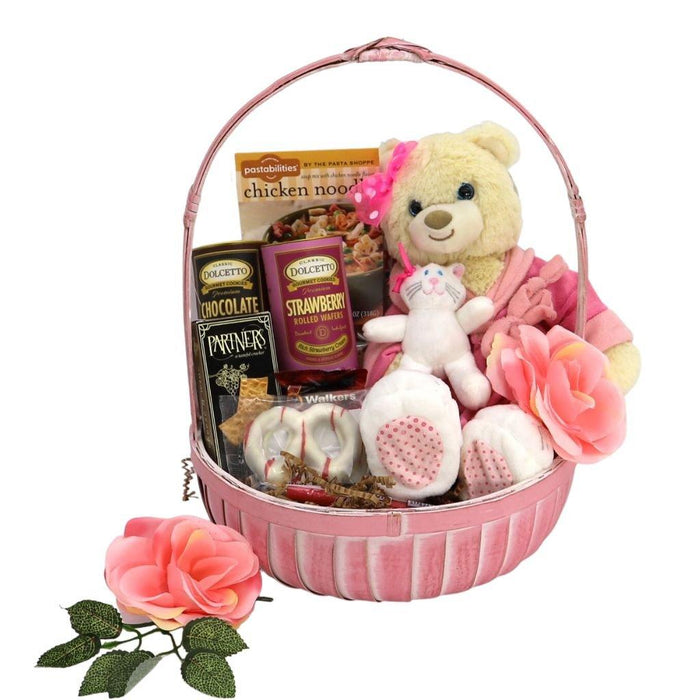 Pink gift basket with plush bear, rose, chocolate packs, and chicken noodle box