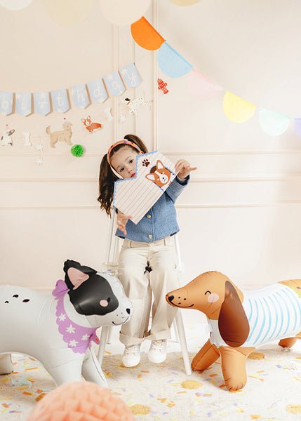Standing bulldog-style character balloons with cartoon faces, shown near a child