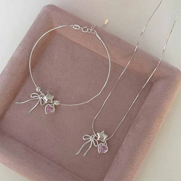 Silver-tone star and heart bow bracelet with clasp and pink heart stones