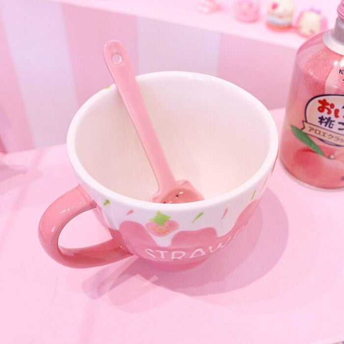 Strawberry milk mug with spoon, pink handle, and strawberry-themed drip graphic