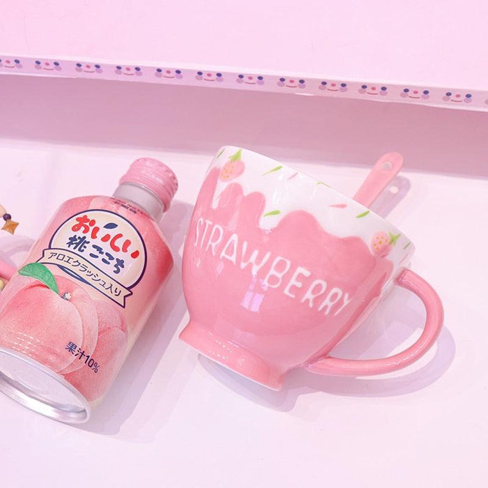 Strawberry milk mug with pink handle, drip design, and strawberry accents