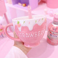 Strawberry milk mug with pink drip design, strawberry accents, and side handle