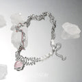 Silver-tone necklace with strawberry-heart charm, pearl beads, and heart pendant detail