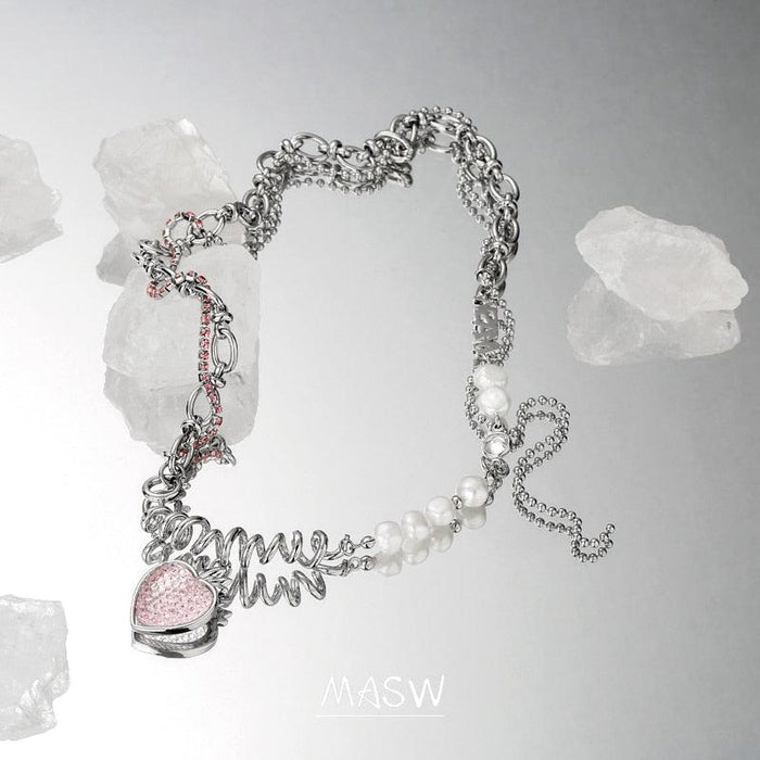 Silver-tone necklace with strawberry-heart charm, pearl beads, and heart pendant detail