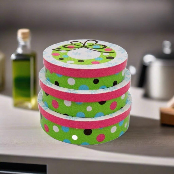 Stacked holiday snack gift tins with colorful polka-dot stripe lid and top cover