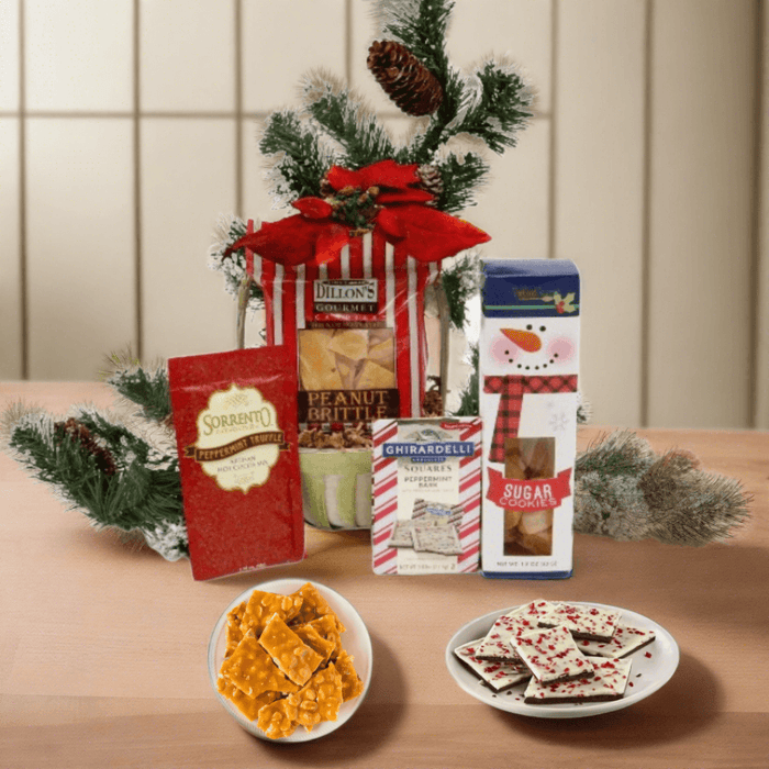 Holiday gift basket with red bow, pine sprigs, and assorted packaged sweets