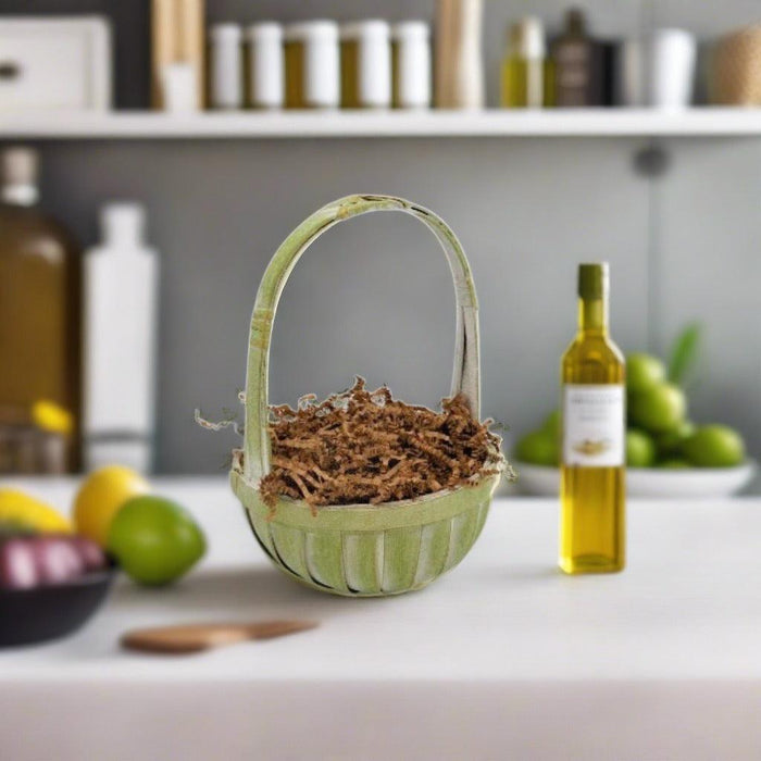 Green basket with shredded filling and handle, set on a table