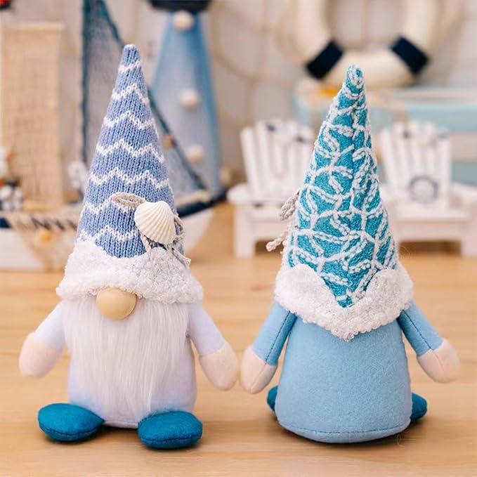 Two beach gnome plush decorations, striped hats with shell accents, white beard, blue feet