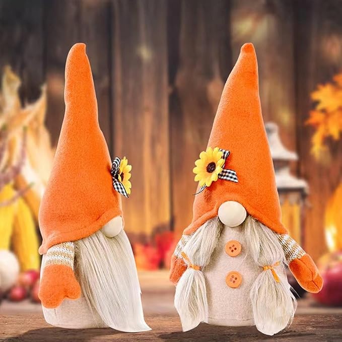 Two plush gnomes standing side by side, orange hats with sunflower pins and button vests