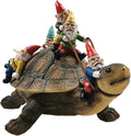 Resin turtle yard ornament with gnomes sitting on its shell, colorful hats and robes