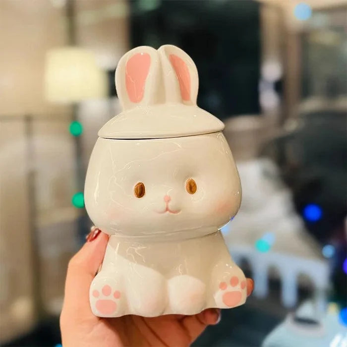 Ceramic bunny-lid mug, white body with pink inner ears and paw-print accents
