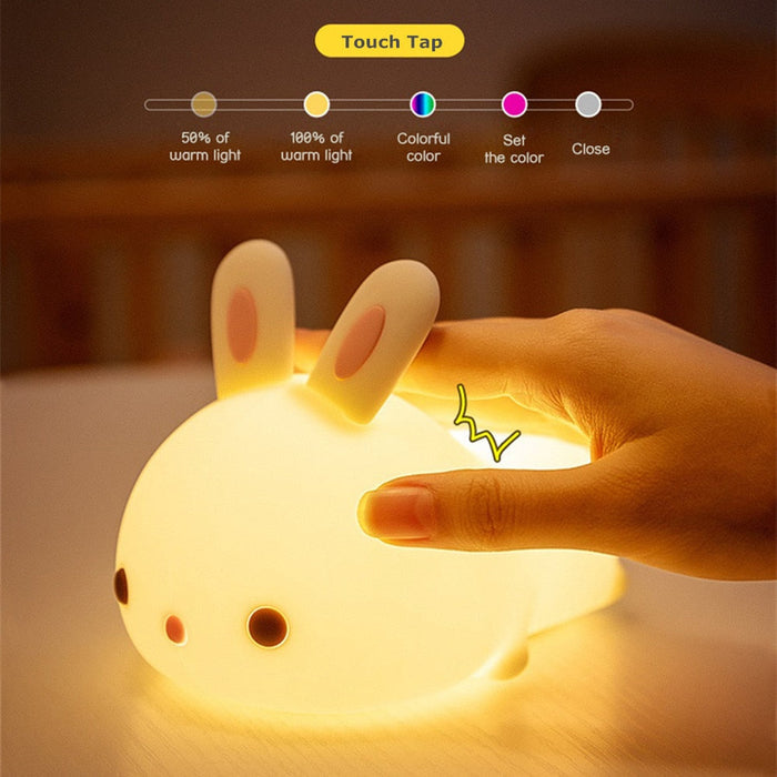 Glowing white bunny night light with touch control icons and warm light output.