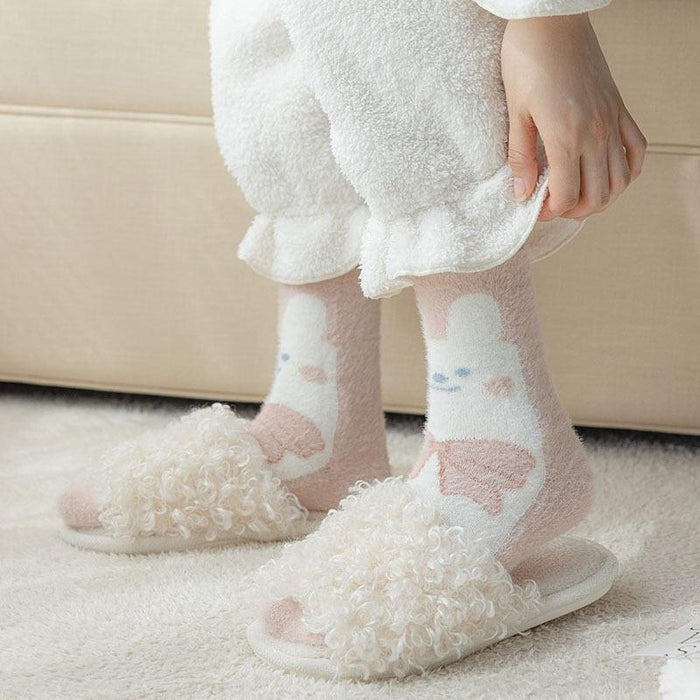 Bunny-themed fuzzy socks with light pink hearts and paw prints