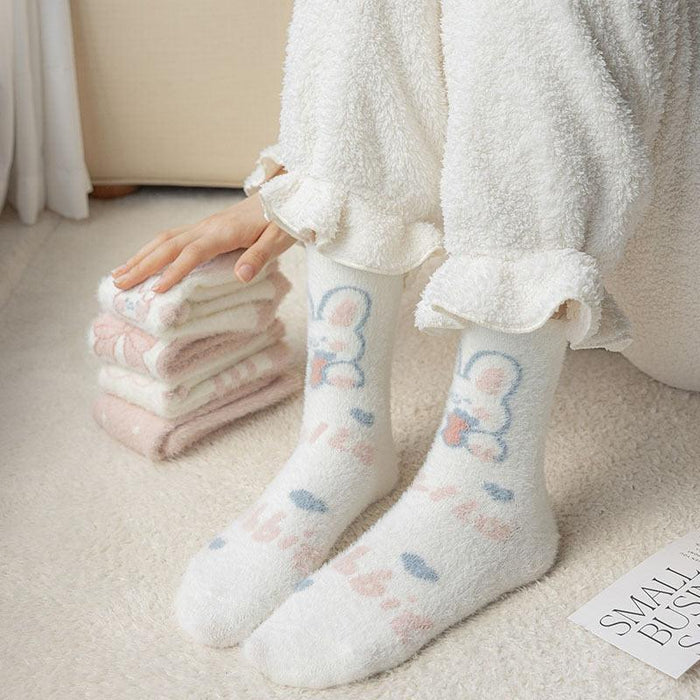 Pair of pastel bunny-pattern socks with blue bow details and soft plush knit cuffs