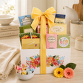Decorative sweet gift basket with floral design, assorted candy boxes, yellow ribbon bow