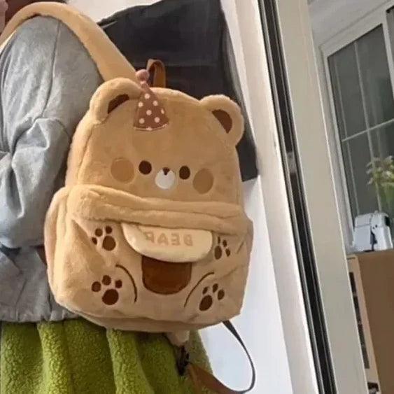 Plush bear backpack light tan with polka-dot bow and paw-print accents
