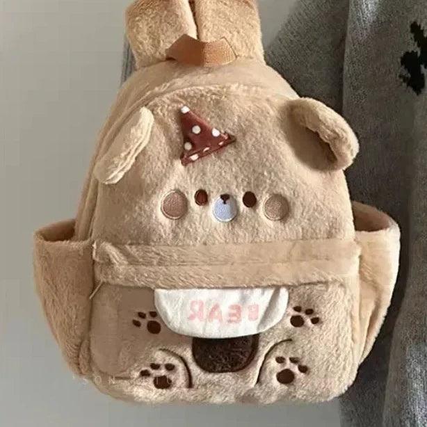 Plush bear backpack light tan with embroidered bear face, polka-dot bow, and pocket