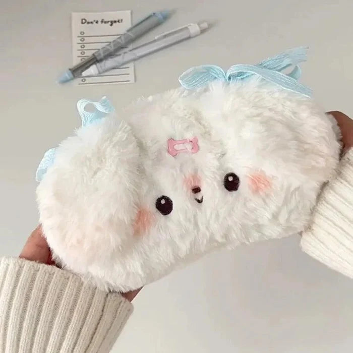 Plush puppy pencil bag with white fur and light blue bow, pink badge front