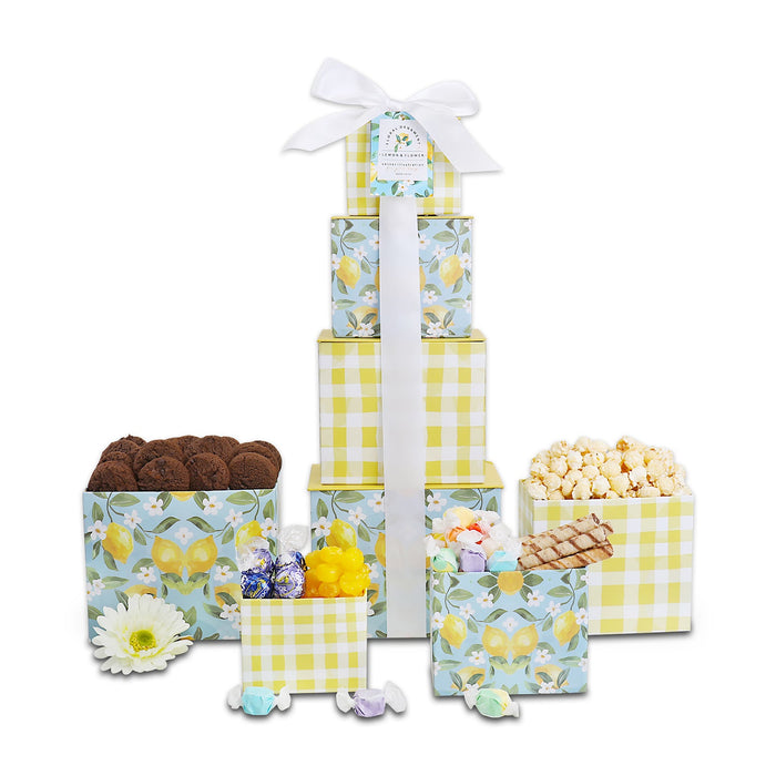 Stacked floral gift tower with yellow gingham boxes, bow ribbon, assorted treats
