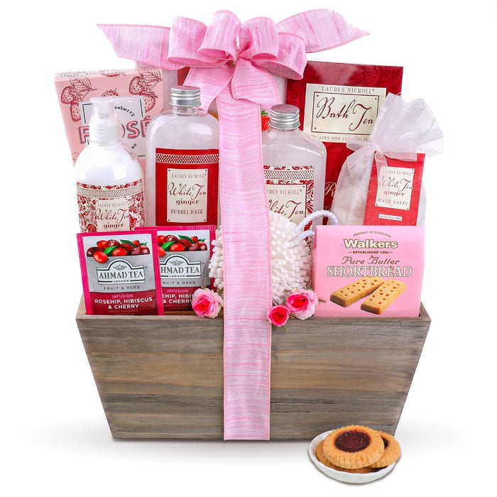 Spa gift basket with pink bow ribbon, wooden crate of bath tea bottles and shortbread