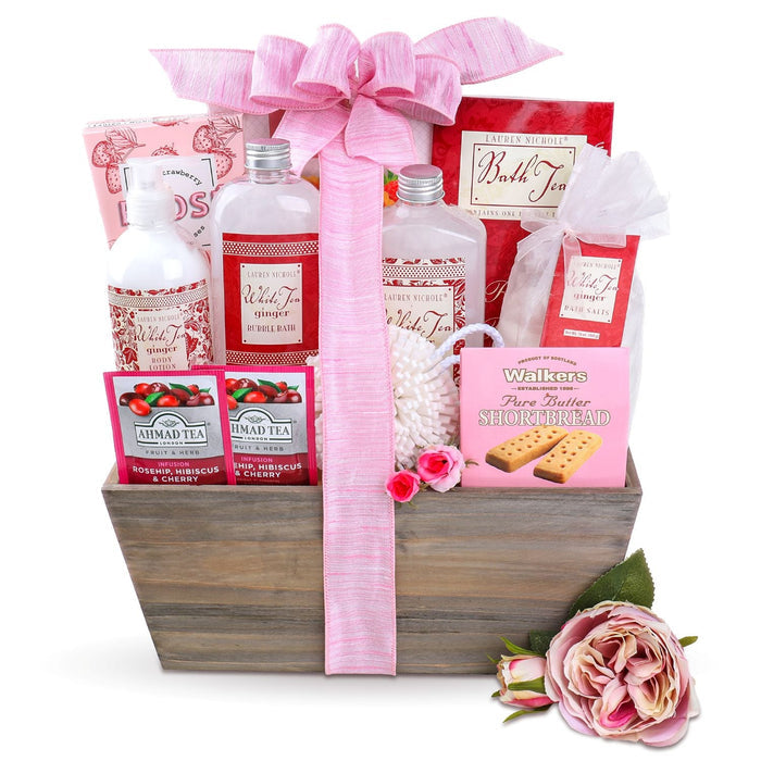 Spa gift basket in wooden crate with pink ribbon, assorted teas, bath salts, and cookies