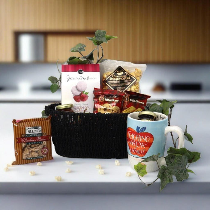 Teacher appreciation gift basket with black woven basket, mug, and assorted packaged snacks