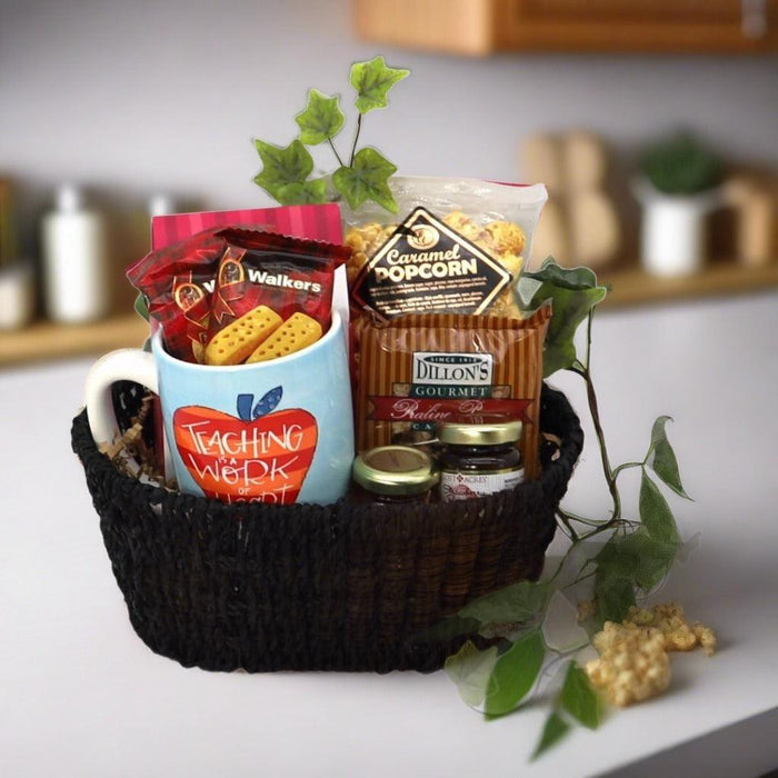 Teacher appreciation gift basket with black woven basket, two mugs, and snack bags