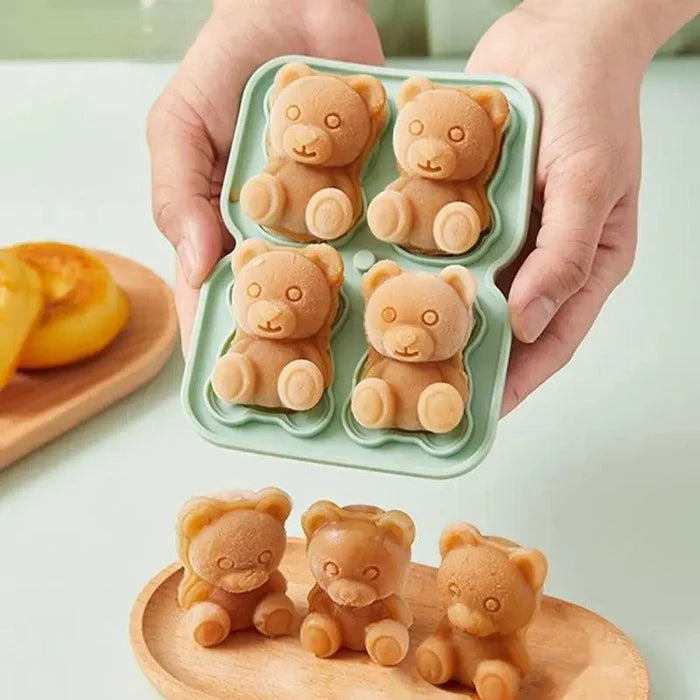 Teddy bear ice mold tray held with four bear-shaped ice pieces