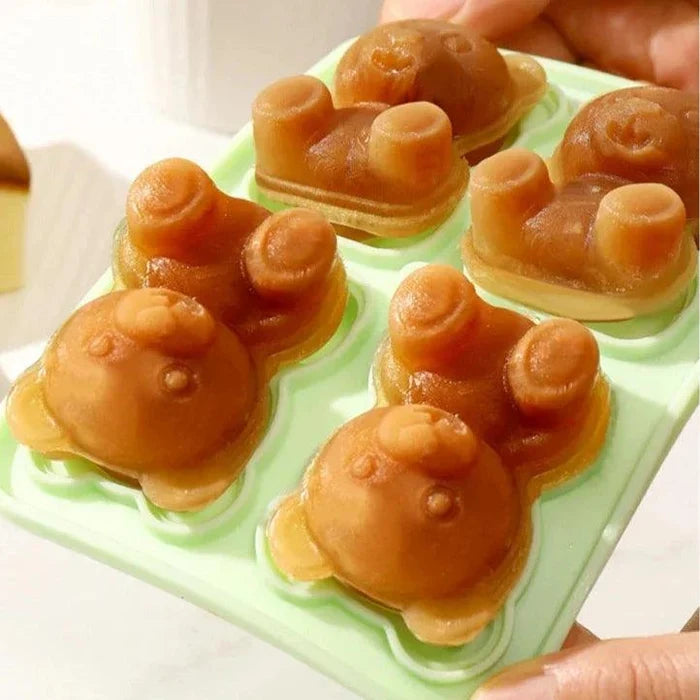 Teddy bear ice mold tray filled with bear-shaped ice pieces and paw details