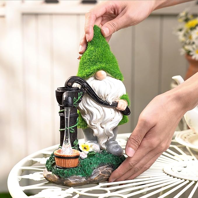 Garden gnome solar lantern decor with green hat and white beard, placed by hand