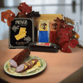 Charcuterie board gift set: crackers, sausage, grapes, and autumn leaves