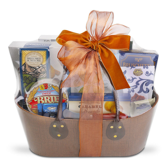 Gourmet gift basket with wrapped crackers, brie, and bruschetta mix, tied with ribbon